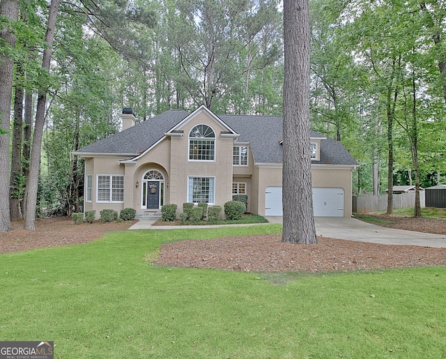 view of front of house with stucco siding, driveway, a garage, and a chimney