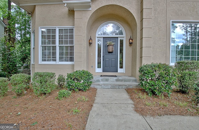 entrance to property featuring stucco siding