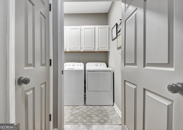 laundry room with cabinet space and washing machine and clothes dryer