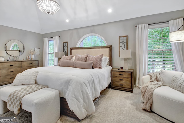 bedroom featuring multiple windows, light colored carpet, lofted ceiling, a chandelier, and recessed lighting