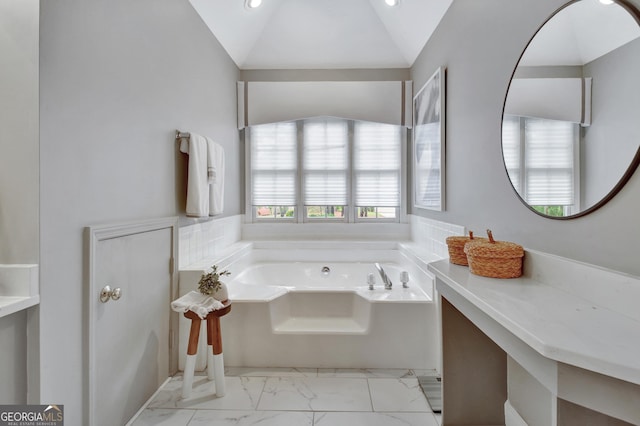 bathroom with a garden tub, marble look tile flooring, recessed lighting, and lofted ceiling