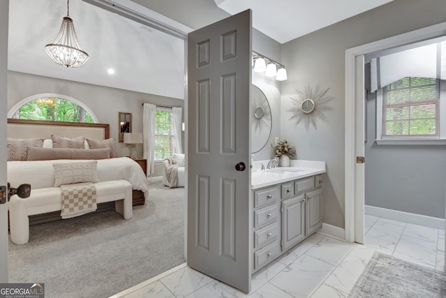 bedroom featuring light marble finish floors, a chandelier, baseboards, a sink, and recessed lighting