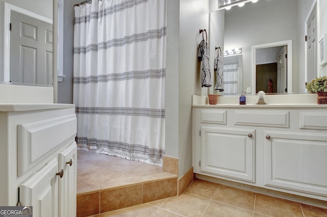 bathroom featuring tile patterned flooring, vanity, and curtained shower