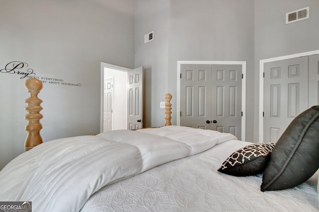 bedroom featuring a high ceiling and a closet