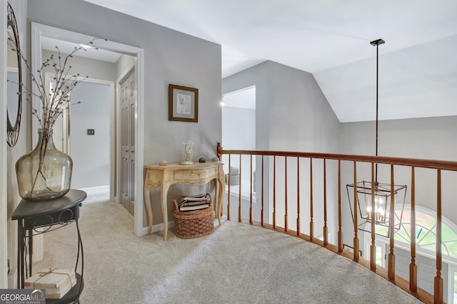 hallway featuring carpet floors and vaulted ceiling
