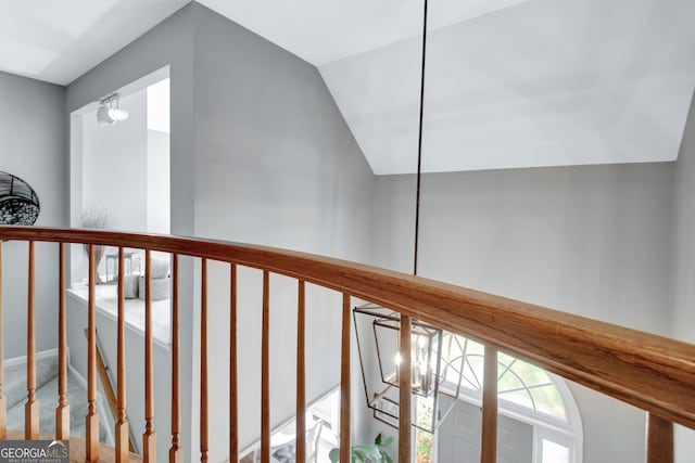 corridor with vaulted ceiling, carpet flooring, and baseboards
