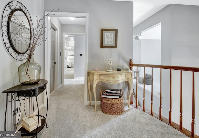 hall with carpet and baseboards