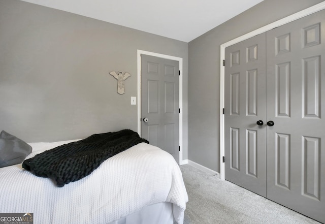 bedroom featuring carpet flooring, a closet, and baseboards