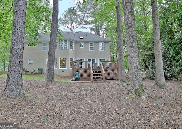 back of property with a wooden deck, stucco siding, crawl space, and central air condition unit