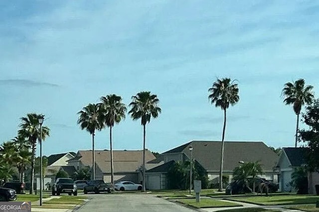 view of road featuring curbs, a residential view, and sidewalks
