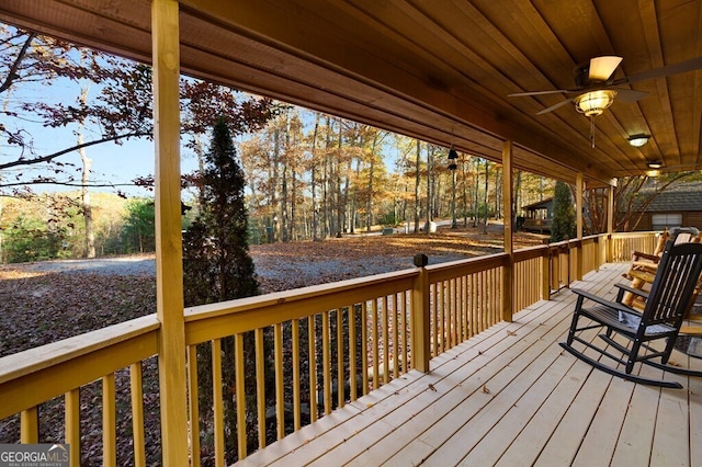 wooden terrace with a ceiling fan