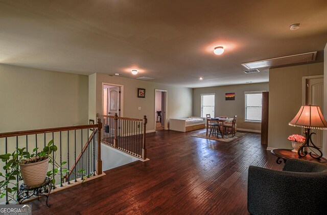 interior space with attic access, wood finished floors, and baseboards