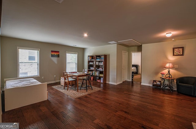 dining space with attic access, wood finished floors, baseboards, and recessed lighting