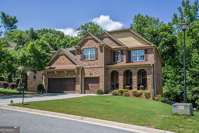 craftsman-style house with driveway, a front yard, a porch, brick siding, and a garage