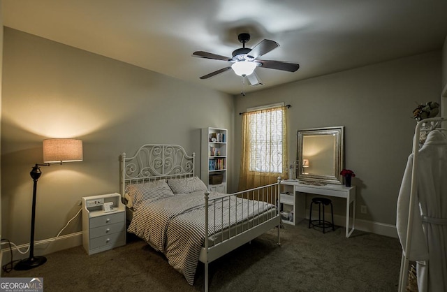 carpeted bedroom with a ceiling fan and baseboards