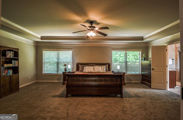 carpeted bedroom with a raised ceiling, crown molding, baseboards, and a ceiling fan