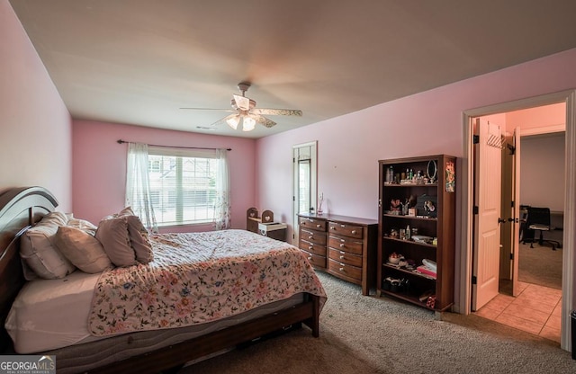 bedroom with light colored carpet and a ceiling fan