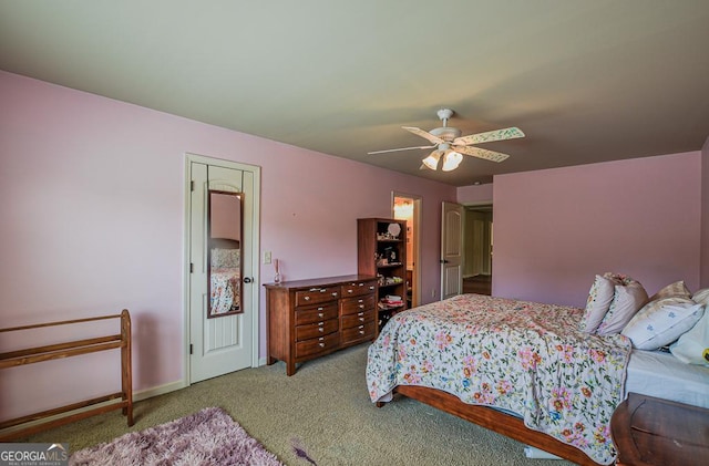 carpeted bedroom with ceiling fan and baseboards