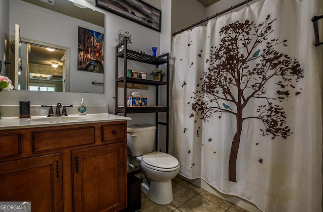 bathroom featuring tile patterned flooring, toilet, vanity, and a shower with curtain