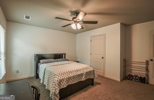 carpeted bedroom featuring baseboards and ceiling fan