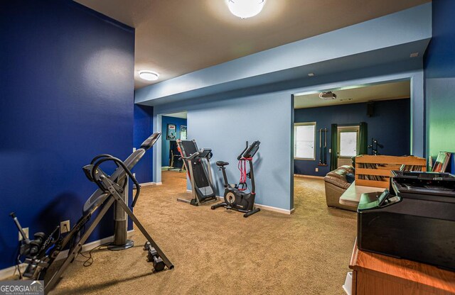 exercise room with carpet flooring and baseboards