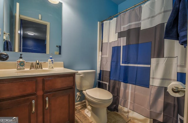 bathroom with toilet, vanity, tile patterned floors, and a shower with curtain