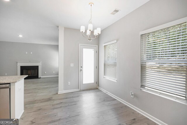 458 Ajo Way, Dallas, GA 30157 - foyer entrance with a chandelier, light wood finished floors, a fireplace, and recessed lighting