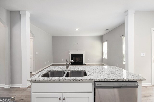 458 Ajo Way, Dallas, GA 30157 - kitchen featuring stainless steel dishwasher, open floor plan, light wood-style flooring, and arched walkways