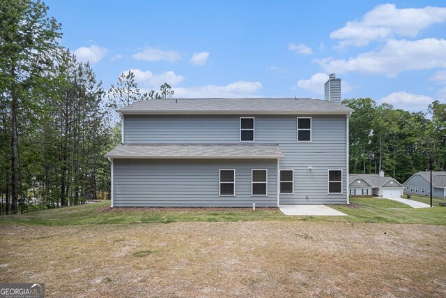 458 Ajo Way, Dallas, GA 30157 - back of house featuring a patio, a chimney, and a lawn