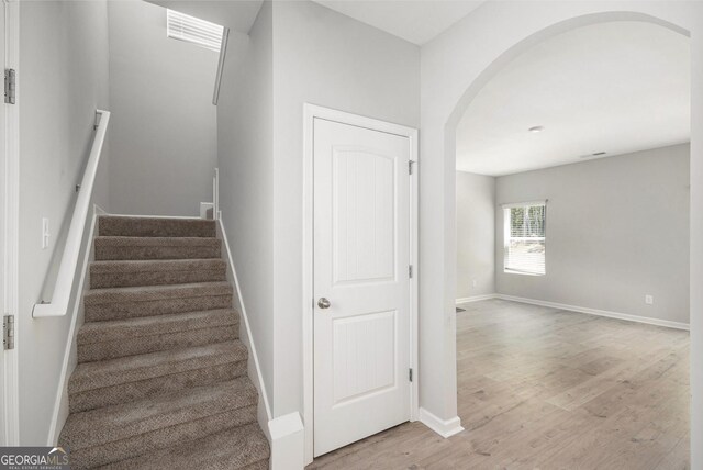 458 Ajo Way, Dallas, GA 30157 - stairway featuring arched walkways and wood finished floors