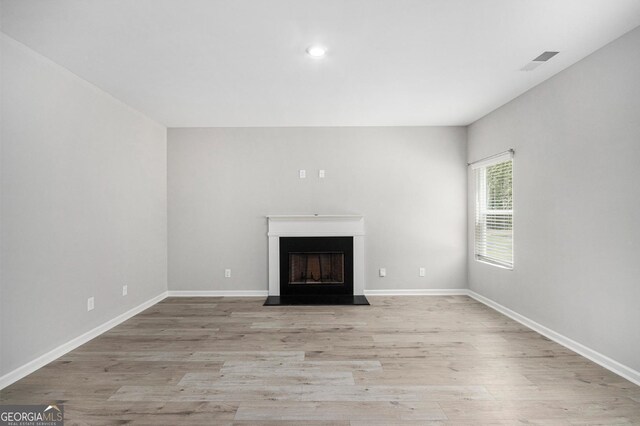 458 Ajo Way, Dallas, GA 30157 - unfurnished living room featuring light wood finished floors, a fireplace with flush hearth, and recessed lighting