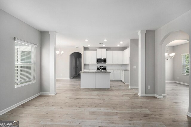 458 Ajo Way, Dallas, GA 30157 - kitchen featuring stainless steel microwave, a chandelier, range, recessed lighting, and white cabinetry