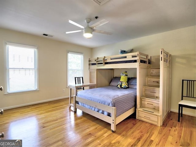 bedroom featuring light wood-style flooring, baseboards, and ceiling fan