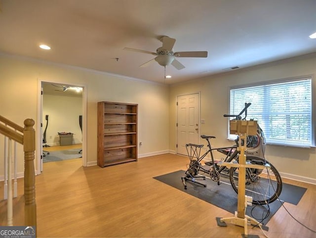 workout room featuring crown molding, ceiling fan, baseboards, recessed lighting, and light wood finished floors
