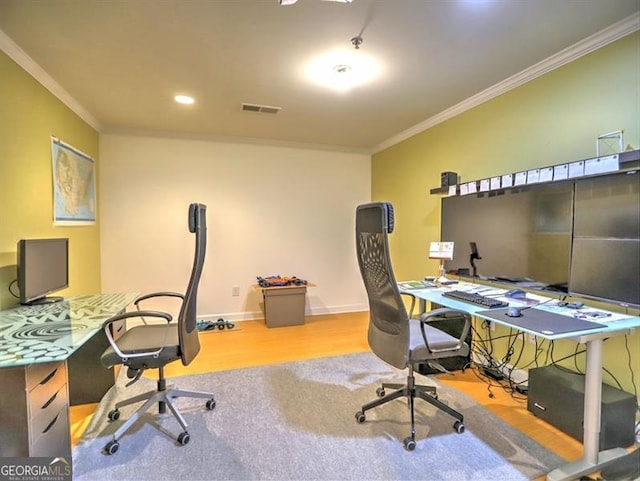 office space with crown molding, wood finished floors, and baseboards