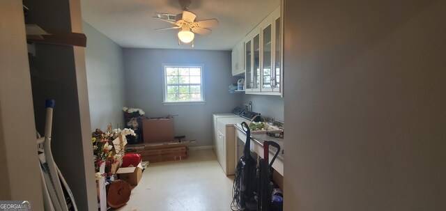 762 Old Mcleod Bridge Rd, Adrian, GA 31002 - laundry area featuring washing machine and clothes dryer and cabinet space