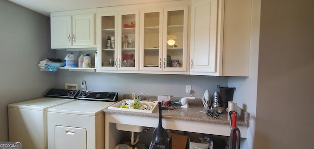 762 Old Mcleod Bridge Rd, Adrian, GA 31002 - laundry room featuring washing machine and clothes dryer and cabinet space