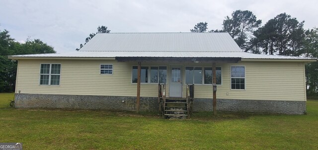 762 Old Mcleod Bridge Rd, Adrian, GA 31002 - back of house featuring a yard, metal roof, and entry steps