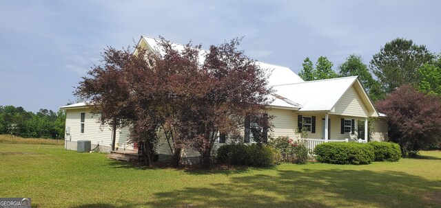 762 Old Mcleod Bridge Rd, Adrian, GA 31002 - view of home's exterior featuring central air condition unit, covered porch, and a lawn