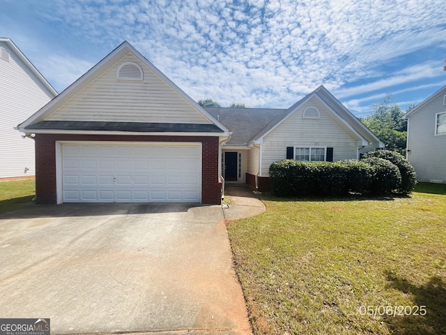 view of front of property featuring brick siding, a front yard, a garage, and concrete driveway