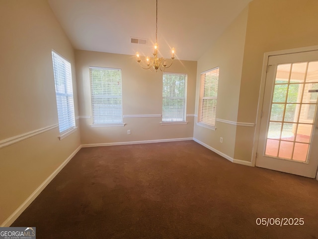 unfurnished dining area featuring vaulted ceiling, a chandelier, dark colored carpet, and healthy amount of natural light