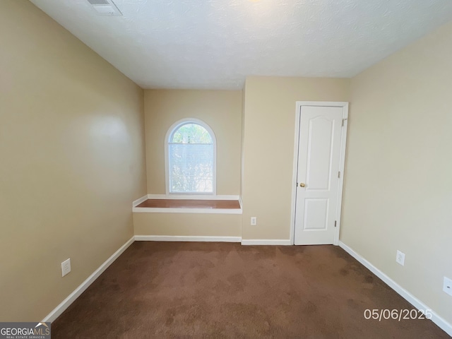 unfurnished room with baseboards and carpet