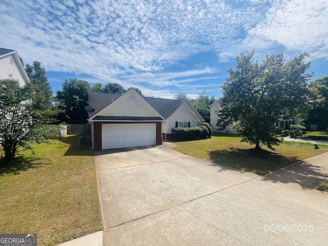 view of front of home featuring a front yard, concrete driveway, and an attached garage