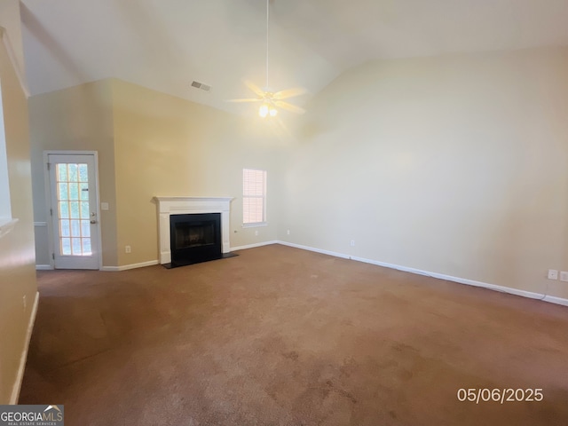 unfurnished living room featuring a ceiling fan, carpet flooring, high vaulted ceiling, healthy amount of natural light, and a fireplace with flush hearth