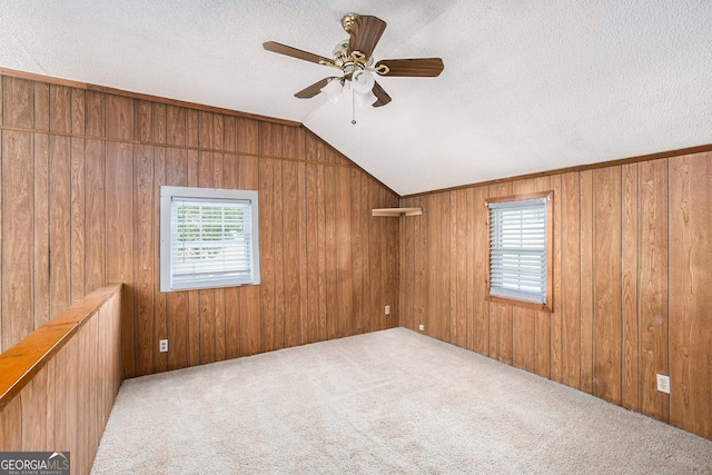1795 Hutcheson Ferry Rd, Whitesburg, GA 30185 - carpeted empty room featuring ceiling fan, a textured ceiling, lofted ceiling, and wooden walls
