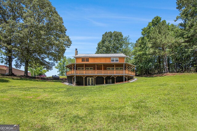 1795 Hutcheson Ferry Rd, Whitesburg, GA 30185 - rear view of property with a chimney, a lawn, a deck, and metal roof