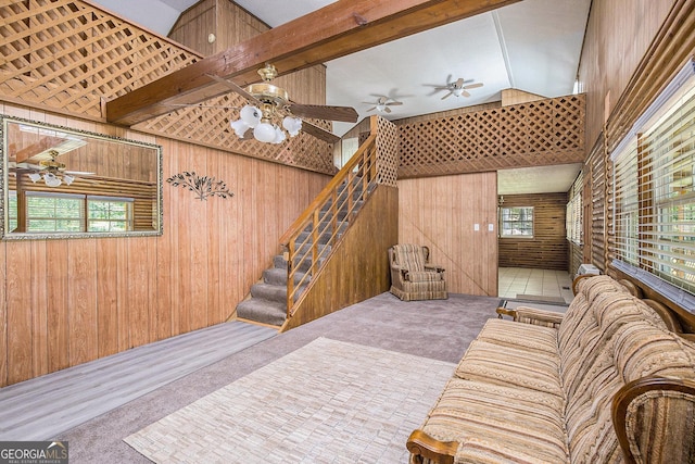 1795 Hutcheson Ferry Rd, Whitesburg, GA 30185 - carpeted living area with wood walls, a ceiling fan, stairway, and vaulted ceiling