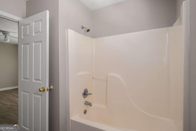 175 Hearth Way, Fairburn, GA 30213 - bathroom featuring shower / tub combination, baseboards, and a textured ceiling