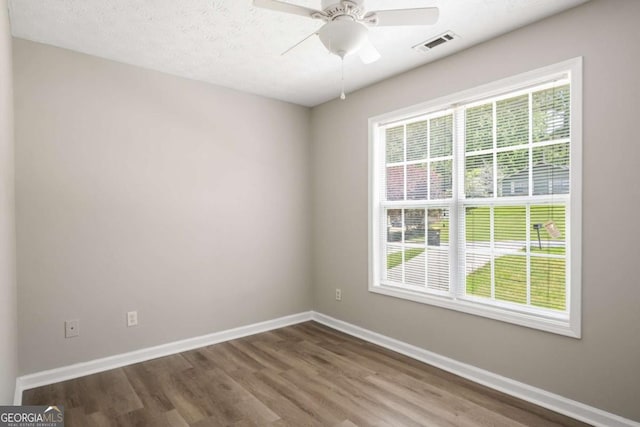 175 Hearth Way, Fairburn, GA 30213 - spare room with plenty of natural light, baseboards, wood finished floors, and ceiling fan