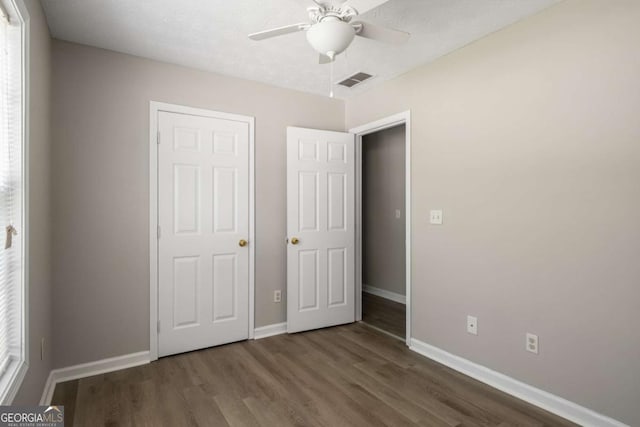 175 Hearth Way, Fairburn, GA 30213 - unfurnished bedroom featuring baseboards, wood finished floors, and ceiling fan
